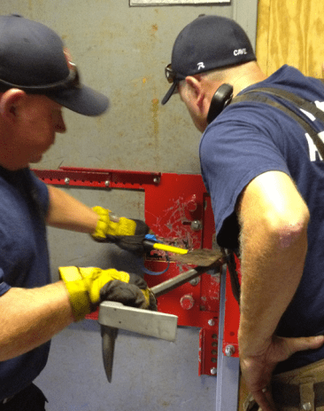 The narrow proportions of a short-handled flathead axe (3-1/2-4 pounds) may be the best choice of striking tool if the forks of your favorite Halligan has square shoulders-- it will reduce the hand sledge's tendency to strike off center and deflect off to the side.